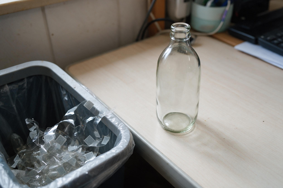 Empty clear glass bottle on table