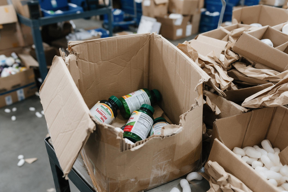 Supplement bottles inside damaged carton box